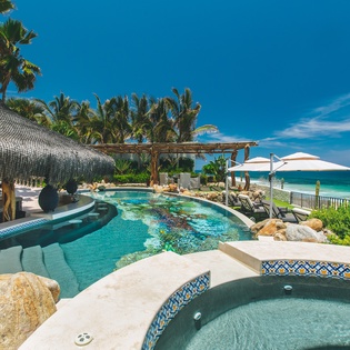 Pool and jacuzzi with beachfront views