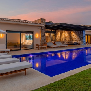Poolside view of exterior during sunset