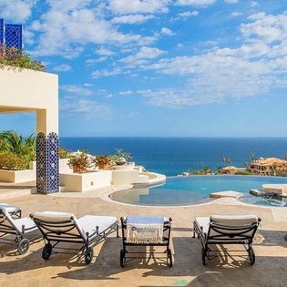 Bask in your private paradise with an infinity pool overlooking endless ocean views, luxurious lounge chairs, and a hanging swing seat—all set against the stunning coastal landscape.