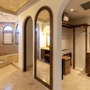 En suite bathroom with bathtub and walk in closet