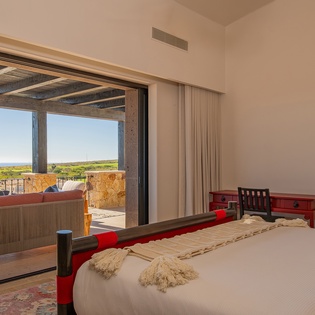 Wake up to stunning sea views from your private bedroom, where morning light streams through floor-to-ceiling windows onto comfortable bedding.