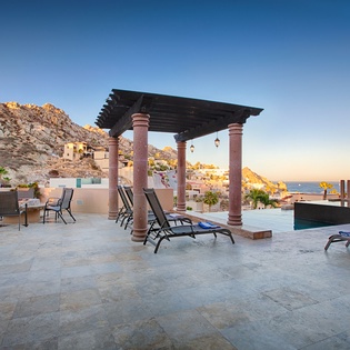 Rooftop terrace with mountain backdrop, pool, and sea views offers an elevated outdoor space for relaxation and entertaining in a scenic hillside setting.