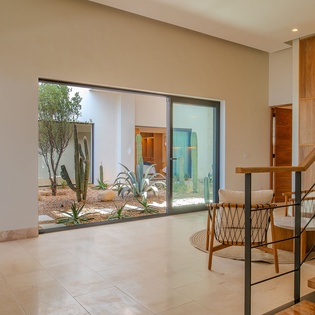 Step into your modern sanctuary where warm wood tones and sleek design create the perfect desert retreat for relaxation.