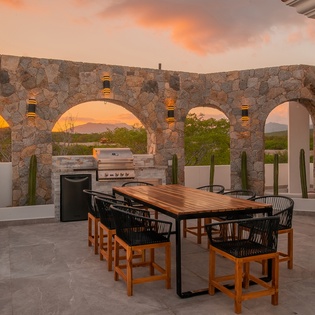 Outdoor dining with BBQ grill sunset