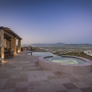 Patio with city and ocean view during sunset