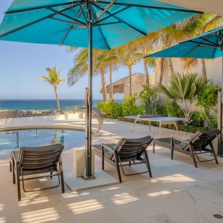 Soak up the sun on your private poolside terrace, where ocean breezes and swaying palms create the perfect escape. Lounge under turquoise umbrellas with stunning sea views stretching endlessly before you.