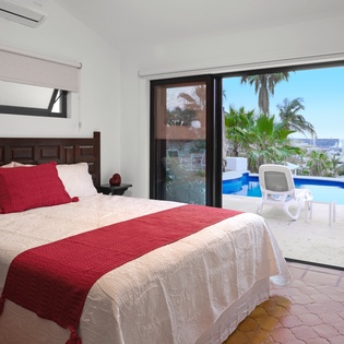 Wake up to tropical bliss in your private bedroom sanctuary, where palm trees and pool views create the perfect vacation escape.
