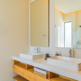 Your spa-like bathroom features dual vessel sinks and modern fixtures for a luxurious morning routine.