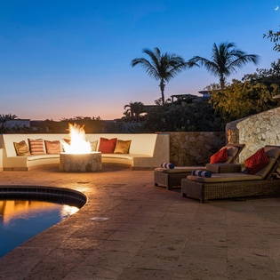 Outdoor seating with firepit during sunset