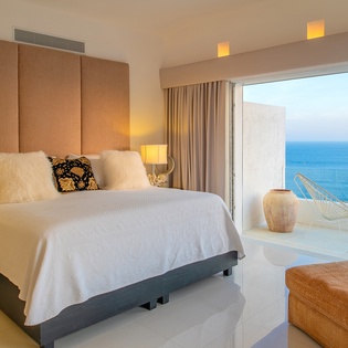 Bedroom suite with terrace and patio access and ocean views