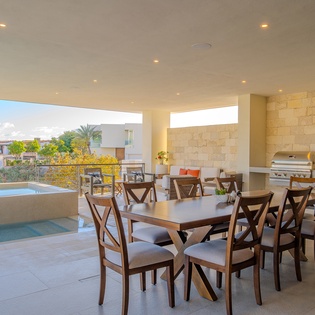 Your covered terrace features elegant dining for eight and a built-in grill, perfect for memorable meals with pool and tropical views.