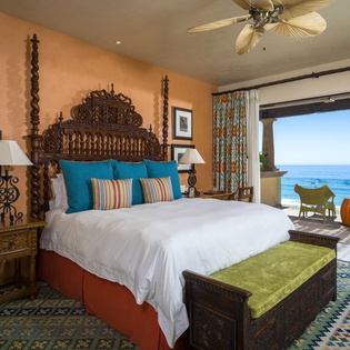 Wake up to endless ocean views from your plush king bed with hand-carved headboard and tropical ceiling fan keeping you cool.