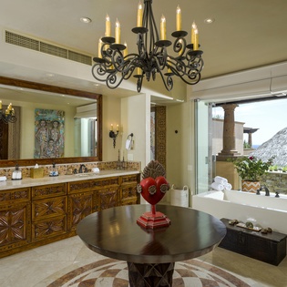 Unwind in your luxurious bathroom sanctuary with handcrafted vanity, elegant chandelier, and peaceful mountain views from your soaking tub.