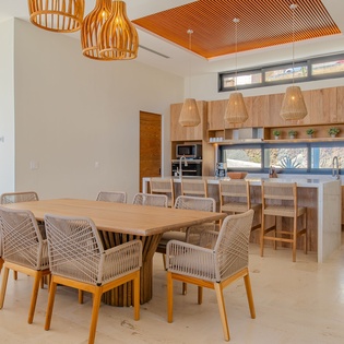 Gather around this stunning dining table where warm wood tones and modern design create the perfect space for your memorable meals together.