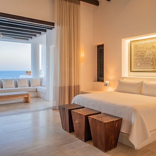 Wake up to pristine white linens and serene ocean views just beyond your terrace. This tranquil retreat blends minimalist elegance with coastal beauty for your perfect escape.