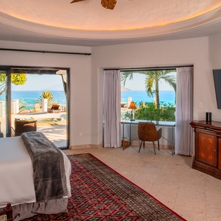 Bedroom suite with patio access and ocean views
