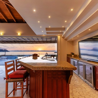 Fully equipped kitchen with bar seating and patio access