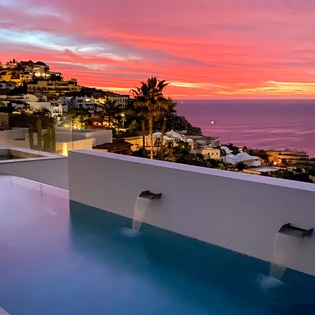 Drift into bliss in your infinity pool as the Mediterranean sky paints itself in coral hues, while hillside villages twinkle below.