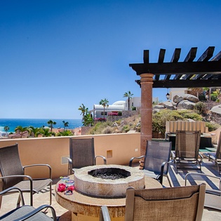 Sparkling sea views and coastal breezes await from this stunning hilltop terrace, featuring a custom fire pit and elegant pergola for memorable oceanfront gatherings.