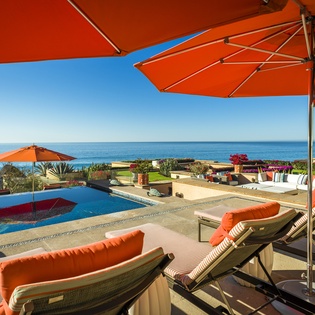 Soak up the sun poolside with panoramic ocean views from your private terrace in paradise.