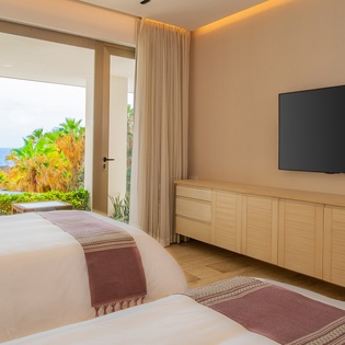 Wake up to stunning ocean views from your comfortable twin beds, with tropical palms framing your private slice of paradise.