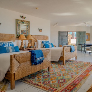 Drift off to sleep in your coastal bedroom with handcrafted beds and stunning ocean views through floor-to-ceiling windows.