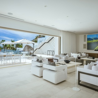 Spacious living area with patio access and ocean views
