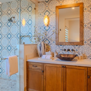 Step into your spa-like retreat with stunning patterned tiles, warm wood vanity, and vessel sink creating the perfect morning routine sanctuary.