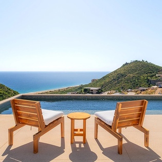 Spectacular ocean and hillside panorama frames this infinity pool sanctuary in a Mediterranean coastal setting.