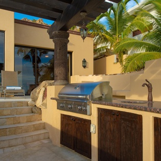 Picture yourself grilling fresh catches under swaying palms at your private outdoor kitchen, perfectly equipped for unforgettable sunset dinners in paradise.