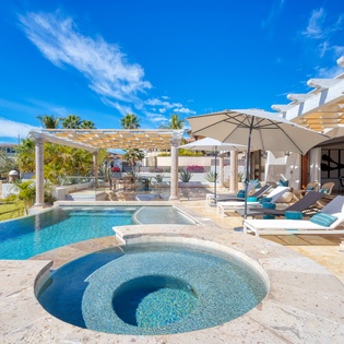 Sunny patio with pool and jacuzzi