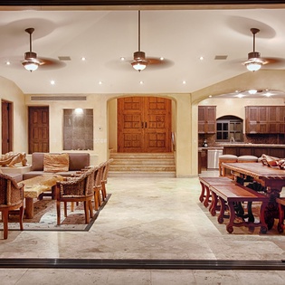 Step into a stunning open-concept living space where rustic elegance meets comfort. Relax on plush seating, gather around handcrafted wood dining tables, and enjoy your fully-equipped gourmet kitchen—all under elegant pendant lighting.