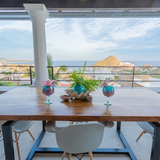 Terrace with outdoor dining and ocean views