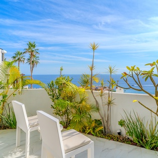 Relax on your private terrace surrounded by lush tropical plants and ocean views.