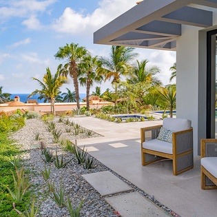 A modern coastal retreat where lush tropical gardens meet the sparkling sea. Relax in stylish shade, dip in your private pool, and breathe in the ocean breeze.