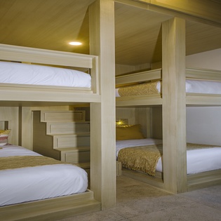 Sleep soundly in your cozy bunk room, where built-in reading lights and soft linens create the perfect retreat.