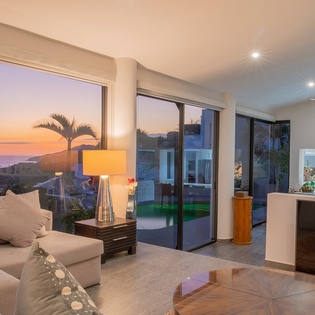 Cozy living area with ocean view during sunset