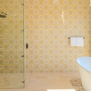 Soak in your private sanctuary with stunning geometric tilework, rainfall shower, and natural sunlight streaming through.