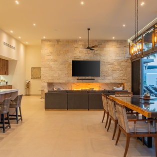 Step into your stunning open-concept living space where modern elegance meets comfort. Stone fireplace, gourmet kitchen, and ocean views create the perfect gathering spot.
