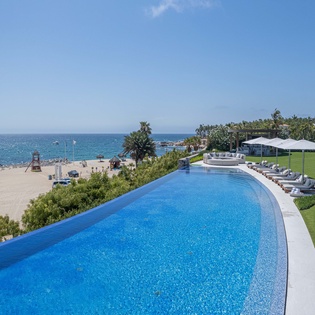 Infinity pool with beachfront views
