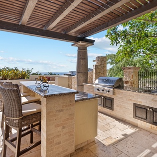 Outdoor bar area with BBQ grill