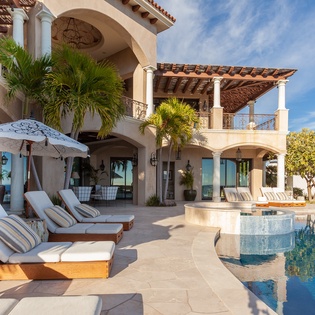 Lounge by the poolside with ocean views