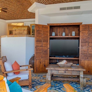 Relax in your inviting living space, where rustic charm meets comfort beneath stunning vaulted brick ceilings and warm wooden accents.