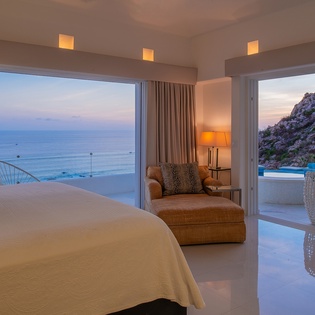 Bedroom suite with terrace and patio access and ocean views