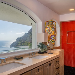 En suite bathroom with double sink and walk in shower