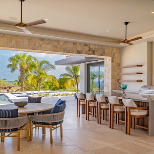 Gather with family and friends in your open-air dining and entertainment area, where tropical breezes blend seamlessly with poolside lounging and a fully equipped outdoor kitchen.
