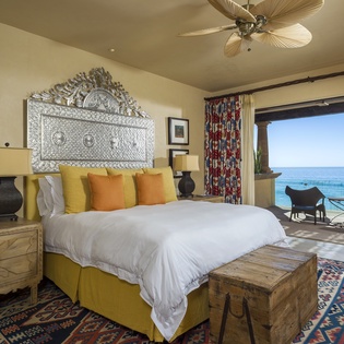 Wake up to stunning ocean views from your elegant bedroom, where handcrafted details and warm colors create your perfect coastal retreat.
