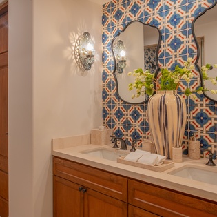 Refresh in your beautifully tiled bathroom featuring dual vanities, elegant lighting, and thoughtful amenities for a luxurious start to each day.