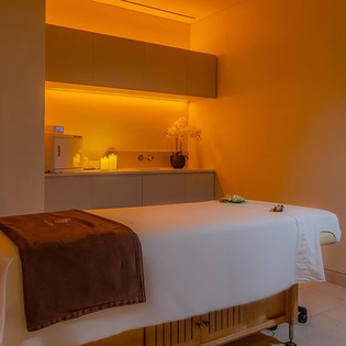 Unwind in your private massage room with warm ambient lighting and professional-grade table for complete relaxation.