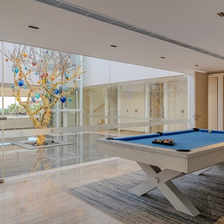 Challenge your friends to a game on this sleek pool table in your bright, modern entertainment space.